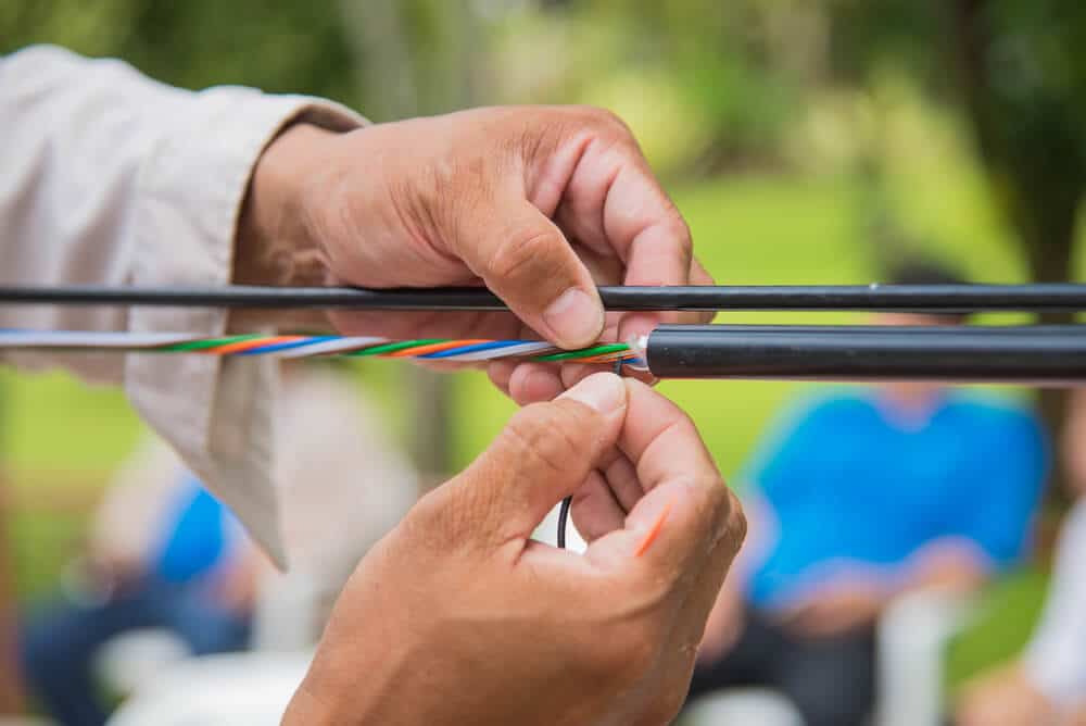 Person constructing a high quality fiber optic cable