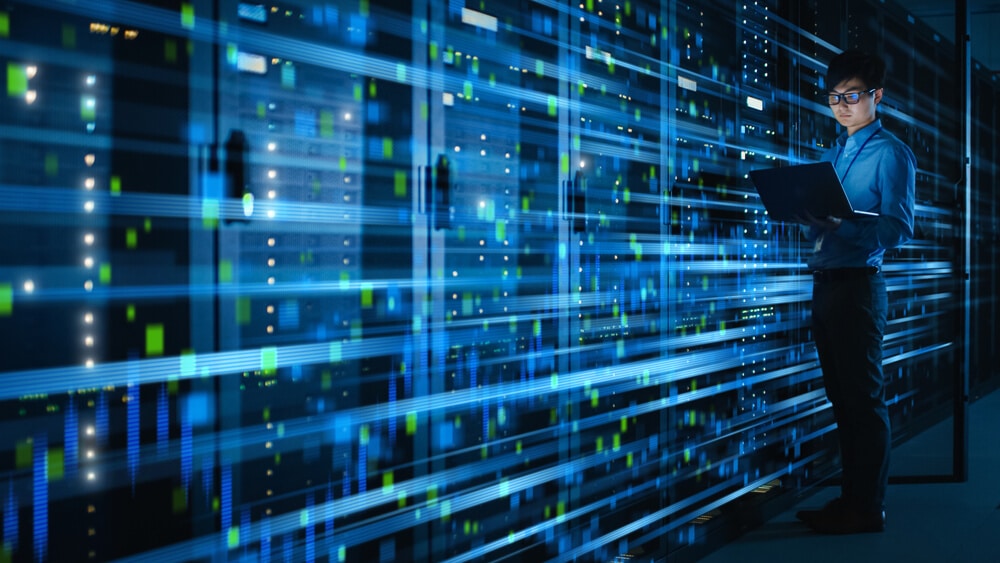 Man with laptop accesses futuristic server in Japan via JAWS.